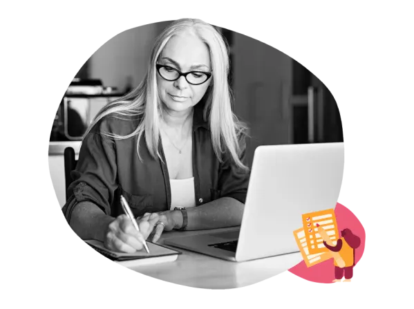 woman writing notes, laptop workspace focus