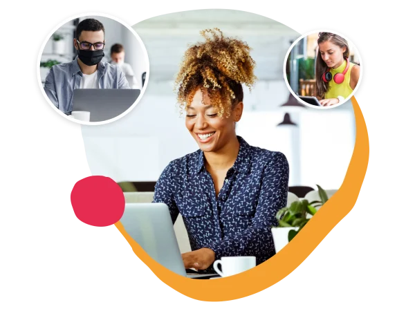 smiling woman using laptop in a vibrant workspace with coffee, focused on digital collaboration, remote work environment with diverse individuals