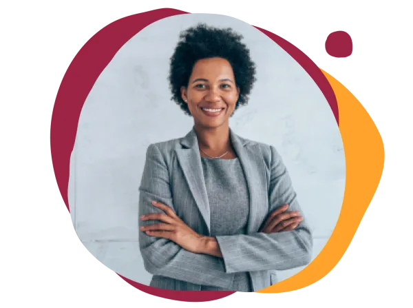professional woman in tailored gray suit with arms crossed, smiling against a light backdrop with colorful shapes, confident businesswoman with curly hair, showcasing modern attire and positive demeanor