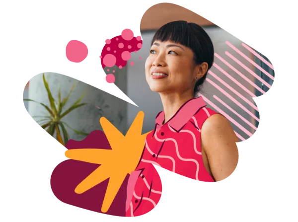 smiling woman in vibrant pink blouse with decorative elements and plants, conveying creativity and positivity, stylish woman with bright decor and cheerful expression