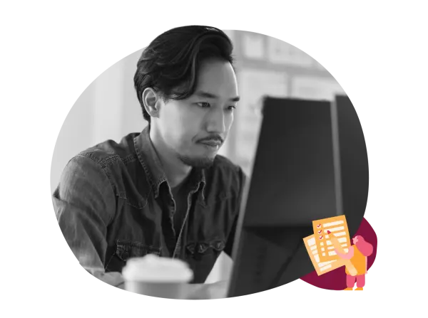focused man, working on a computer, coffee cup in foreground