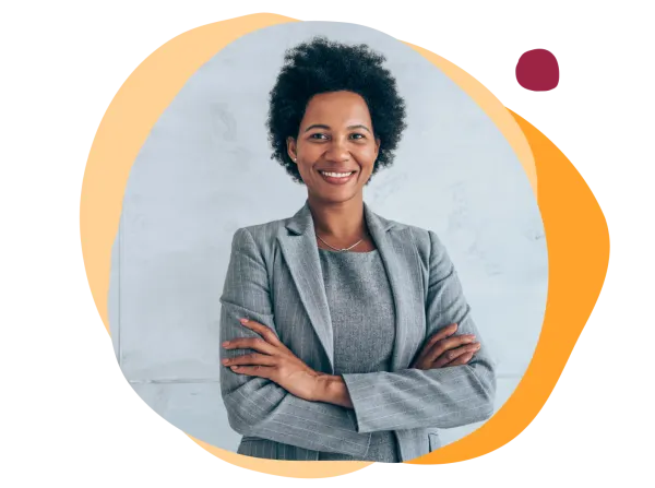 business professional, smiling woman in gray suit with arms crossed against a light backdrop