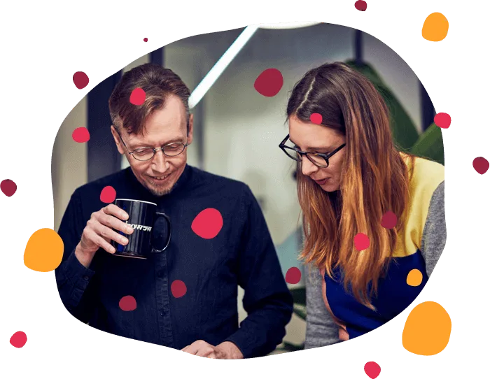 colleagues discussing ideas over coffee in a modern office, colorful shapes in the background, teamwork in a creative workspace