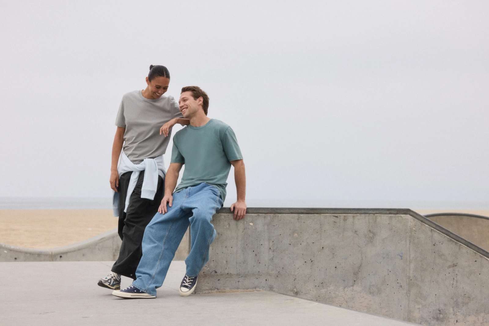 Models wearing organic cotton tees at a skatepark