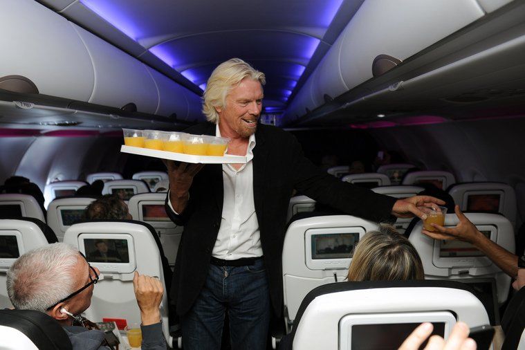 Richard Branson serving orange juice onboard Virgin America