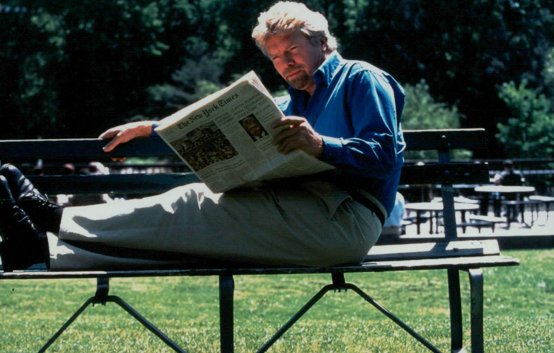 Richard Branson reading the newspaper 