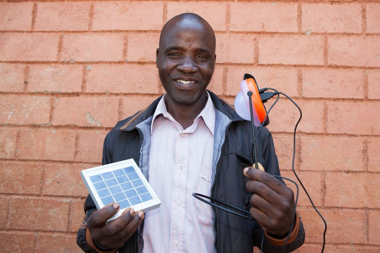 Pico-Solar Lights Man Holds Pico-Solar Light