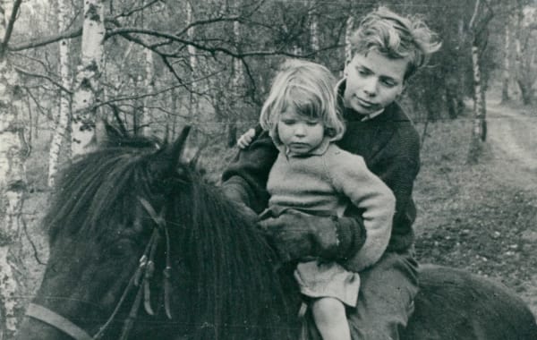 Young Richard Branson riding a horse with his sister