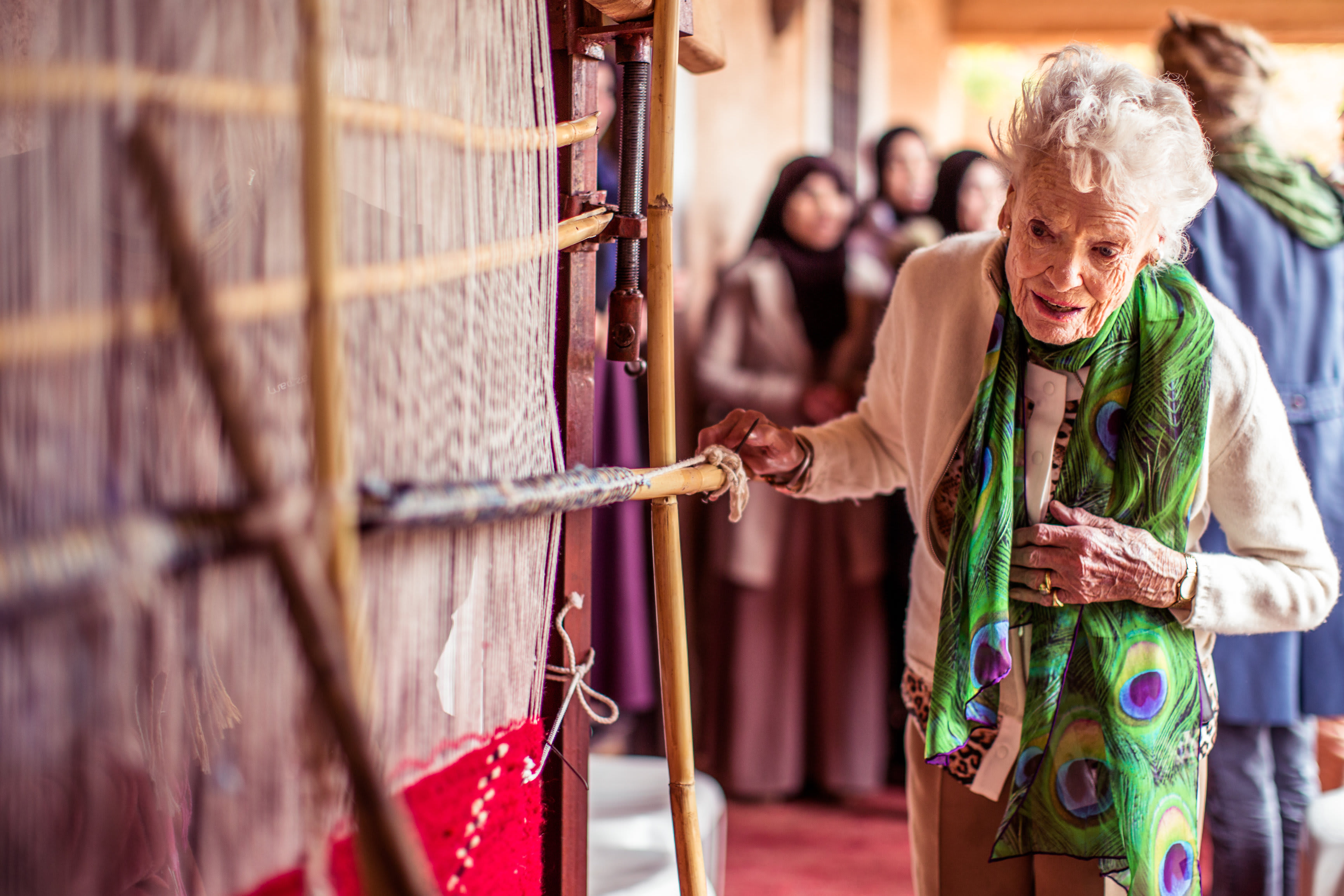 Eve Branson next to a traditional loom Eve Branson next to a traditional loom