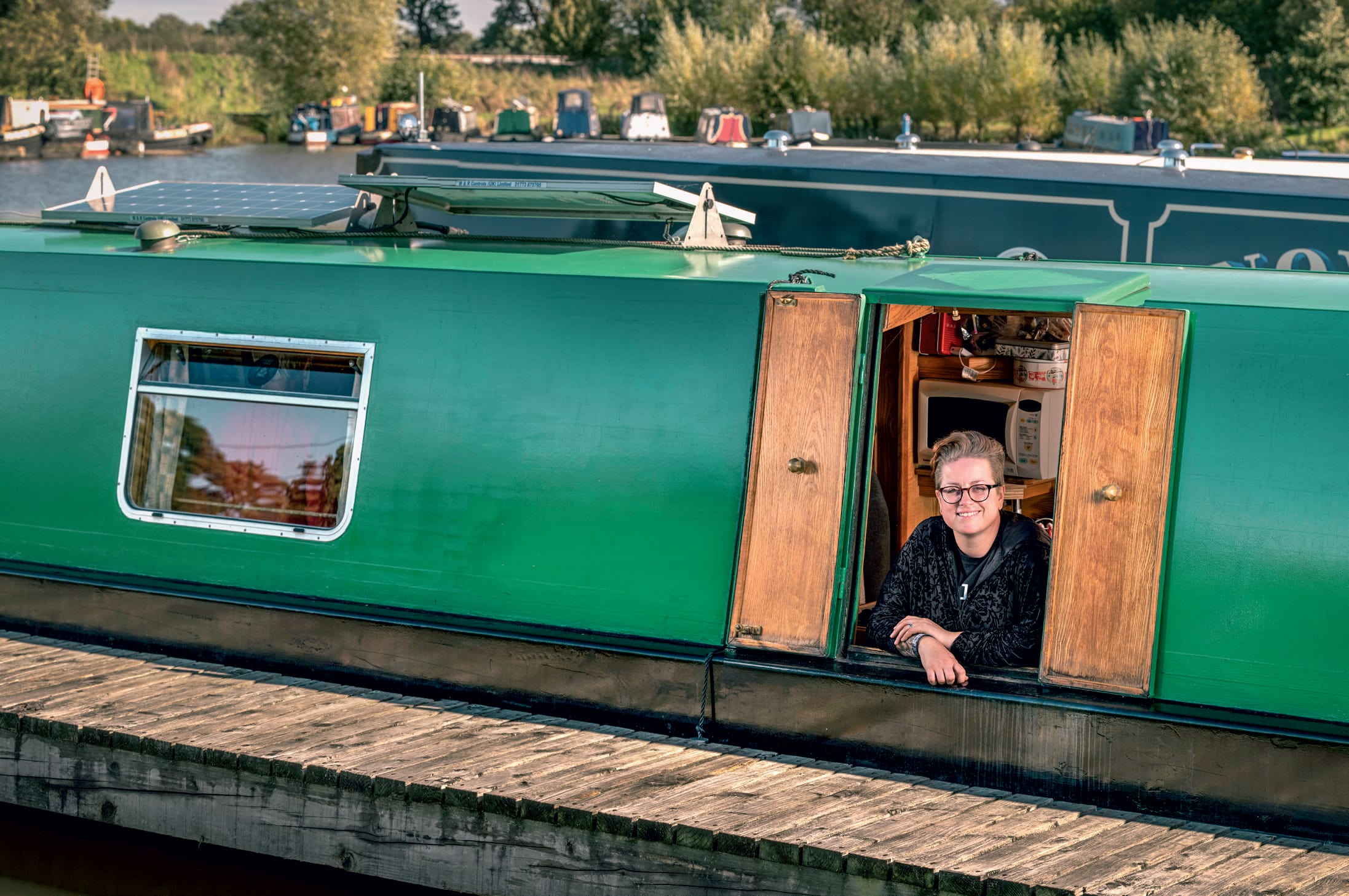 Vic Whitehouse looking out from a window on her narrowboat Vic Whitehouse looking out from a window on her narrowboat