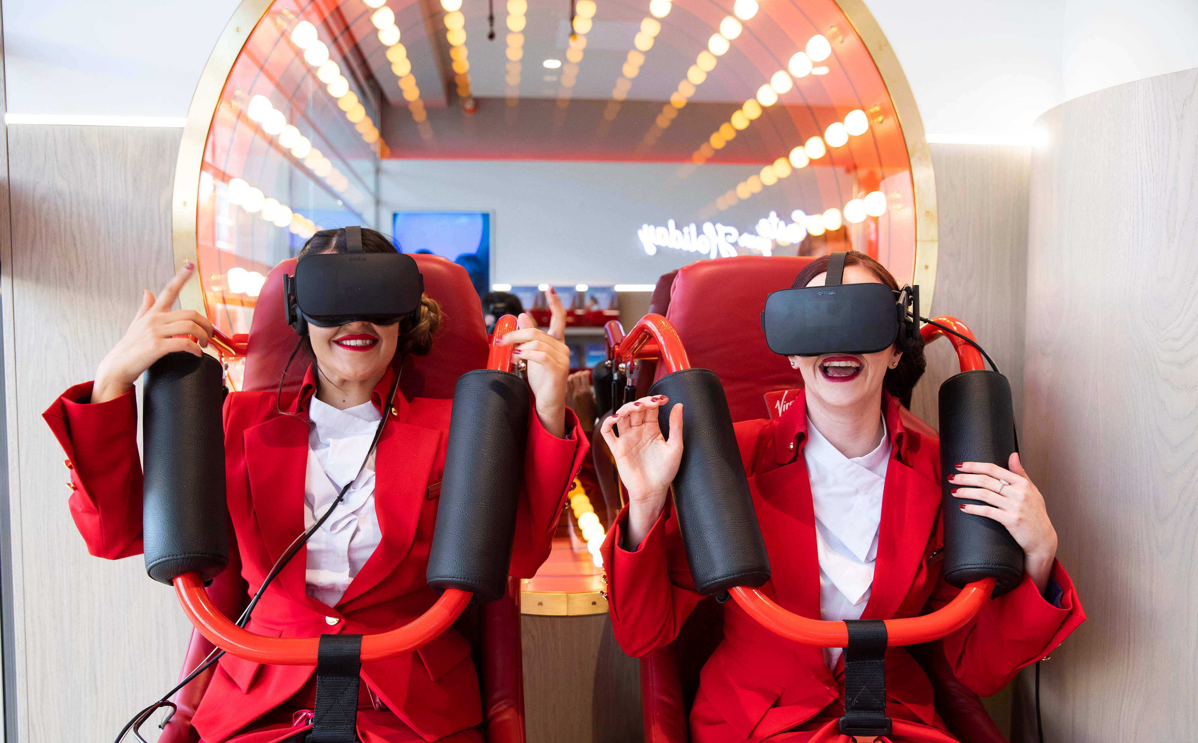 Two Virgin Holidays employees enjoy the virtual reality rollercoaster in store Two Virgin Holidays employees enjoy the virtual reality rollercoaster in store