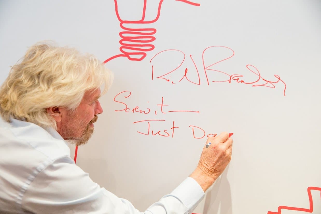 Richard Branson signing a wall Richard Branson signing a wall