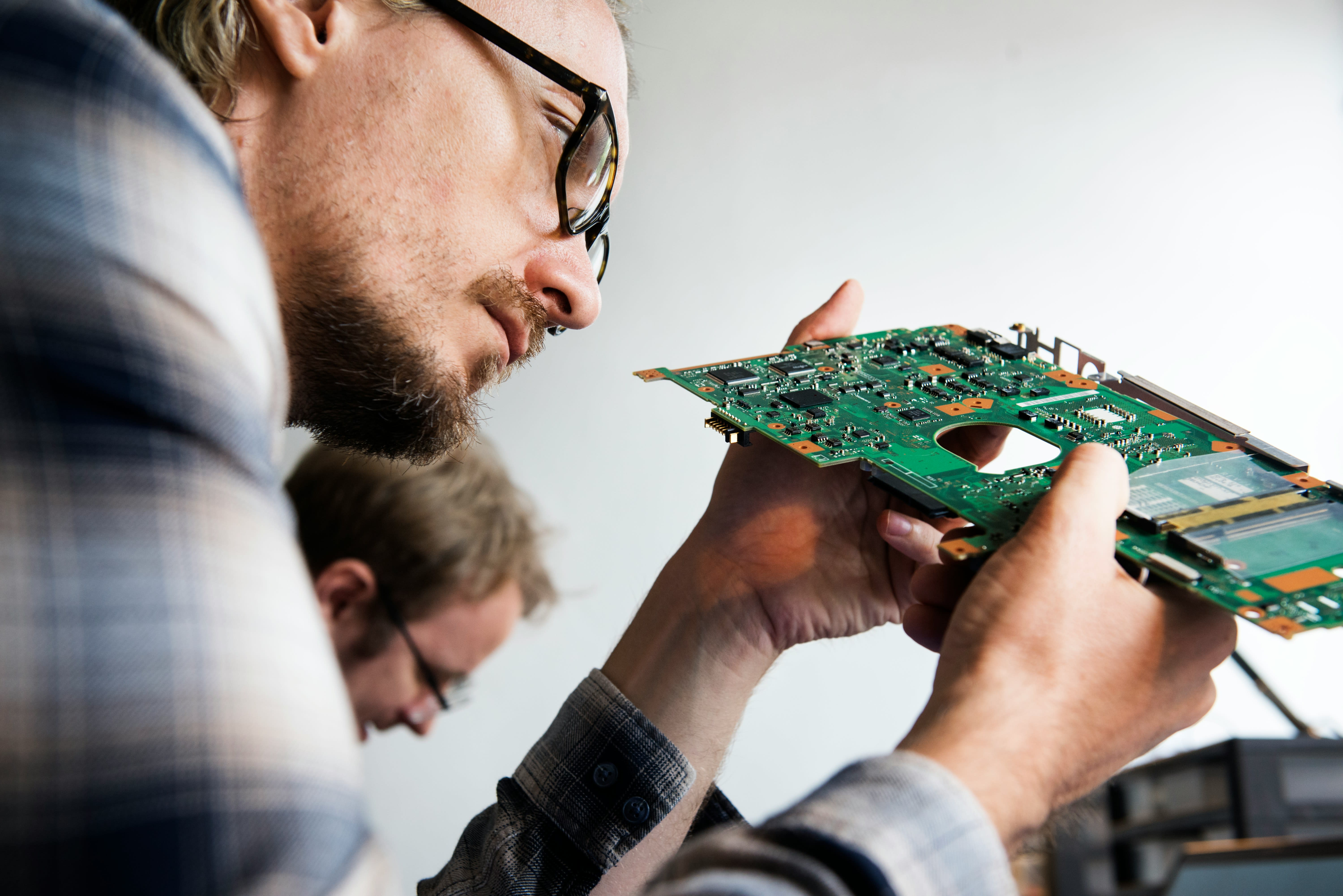 Engineers examining a circuit board
