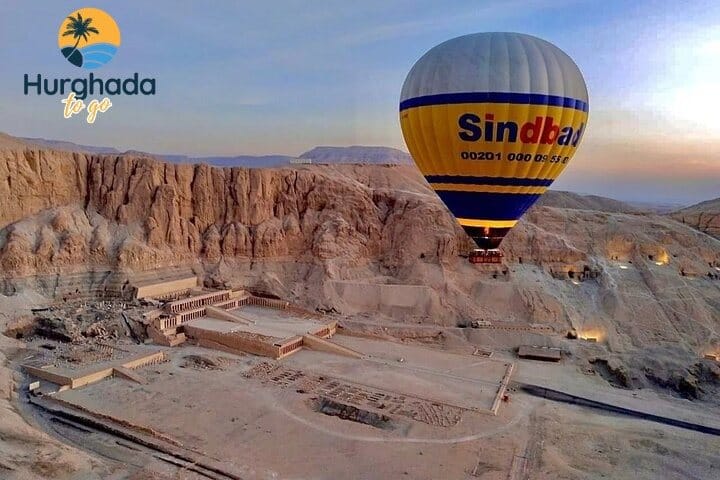 Hot-air balloons flying or preparing to launch over the Nile Valley landscape Hot-air balloons over the Nile Valley at sunrise
