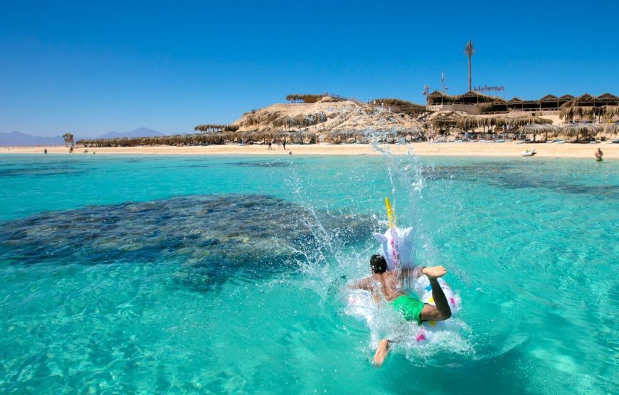 Snorkelers exploring clear water and coral reef scenery — coral reef snorkeling