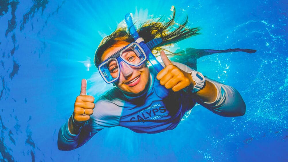 Snorkelers exploring clear water and coral reef scenery — second snorkeling session