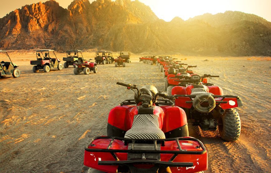 Desert excursion scene with quad bikes, rugged mountains or open sand — desert landscape