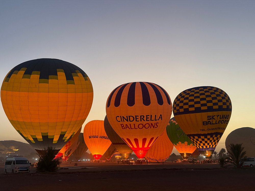 Hot-air balloons flying or preparing to launch over the Nile Valley landscape Hot-air balloons over the Nile Valley at sunrise — Discover the subject