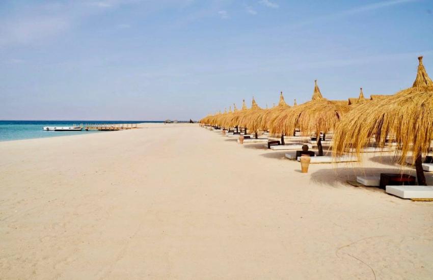 Sandy beach beside clear turquoise Red Sea water