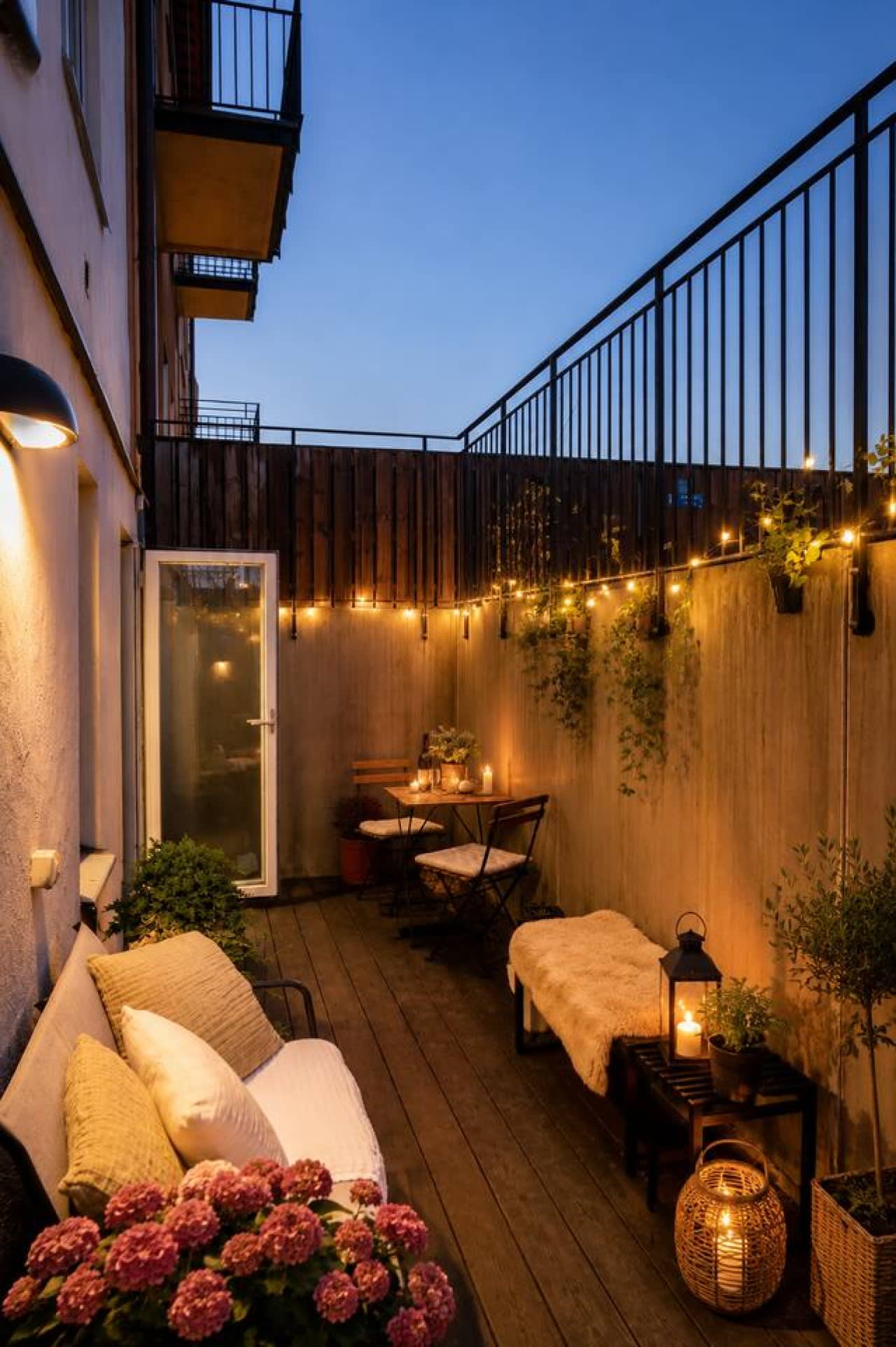 Private terrace with string lights at the Stora Mossen apartment, Bromma