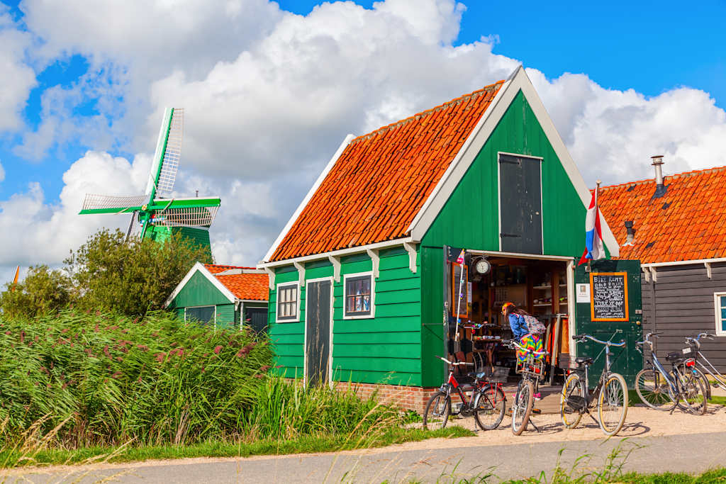 Zaanse Schans, Netherlands - September 02, 2015: windmills at Zaanse Schans with unidentified people. It is a museum village. A collection of historic windmills and traditional houses from the region were moved to the area starting 1961