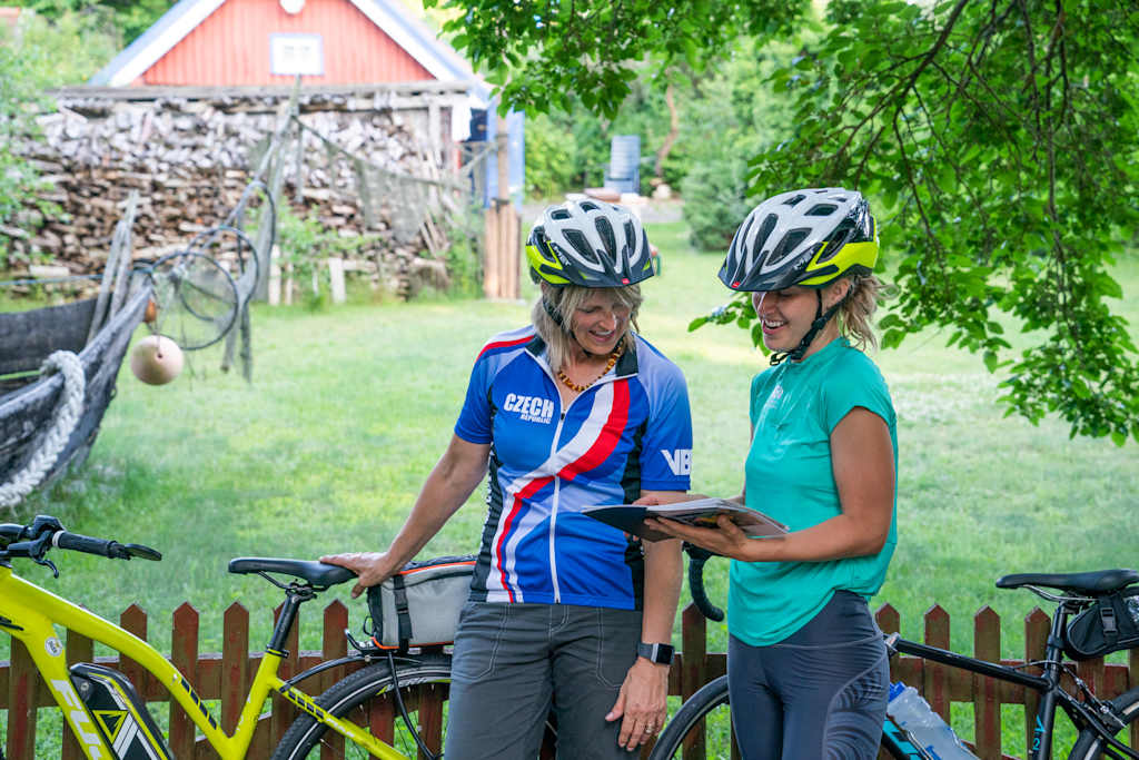 Two VBT guests on a self-guided biking tour reading route notes