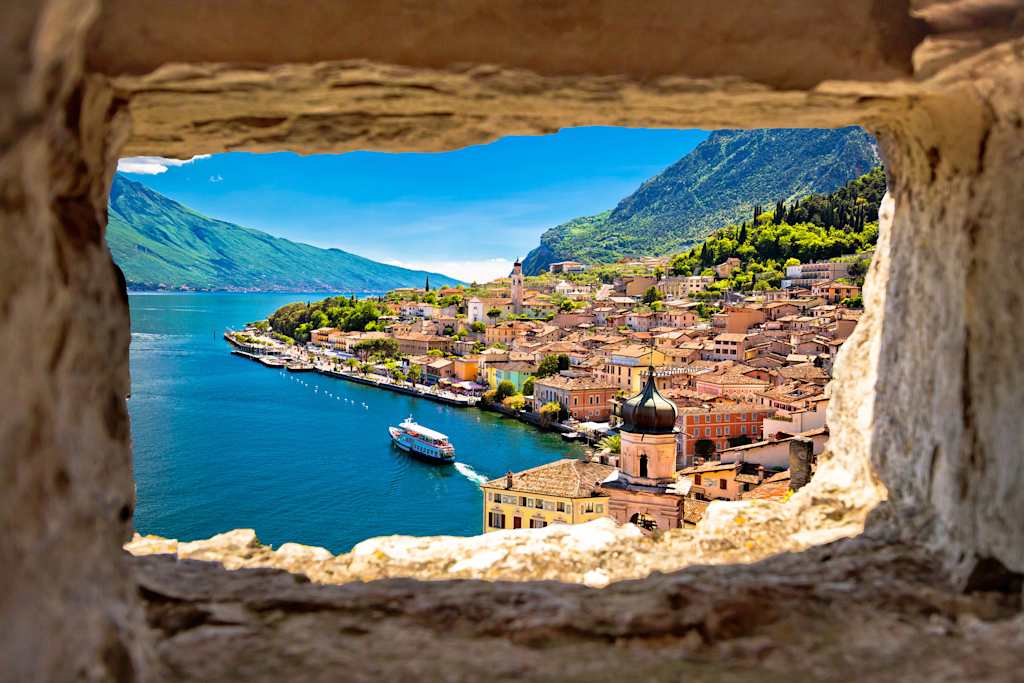 Limone sul Garda view through stone window from hill, Garda lake in Lombardy region of Italy