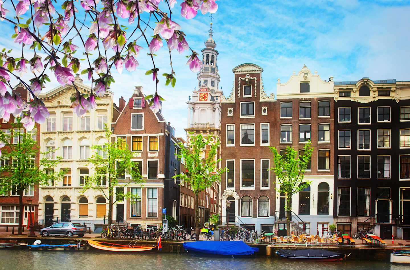 HSB, Holland in Springtime Bike + Boat Aboard The Magnifique III, Waterways 2021 medieval houses on canal in Amsterdam with spring flowers, Netherlands