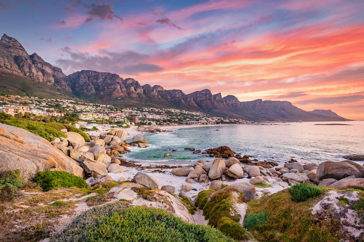 Beautiful sunset twilight view to Camps Bay, Scenic view during colorful sunset with beautiful cloudscape. Camps Bay the famous suburb of the city of Cape Town with white sandy beaches underneath the Table Mountain. Camps Bay, Cape Town, South Africa, Africa