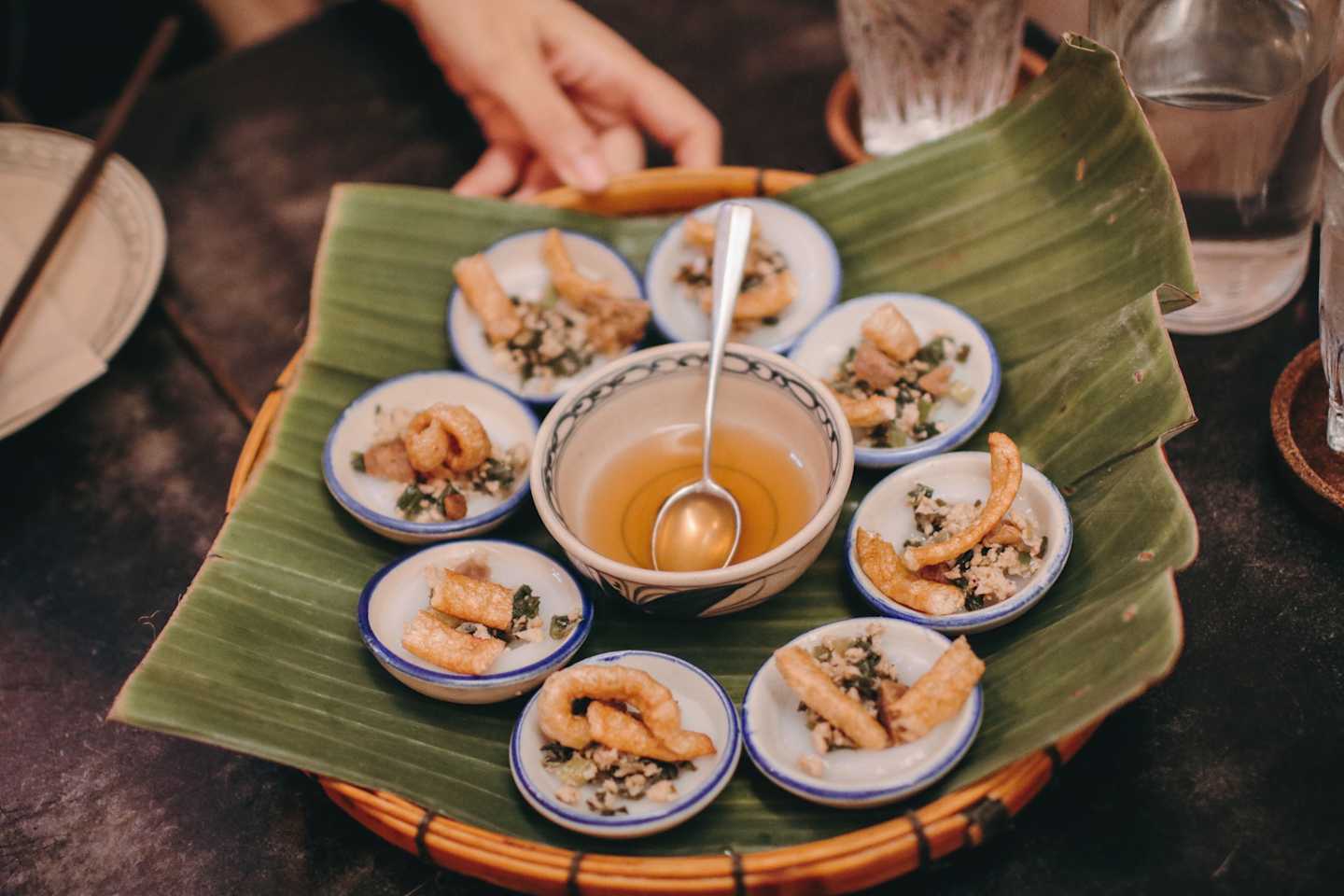 Banh Beo is vietnam food traditional VIETNAM food in mini dish rice pancake with local spice dried shrimp top served in bamboo basket tray with mild clear source and fresh green clean vegetable as app
