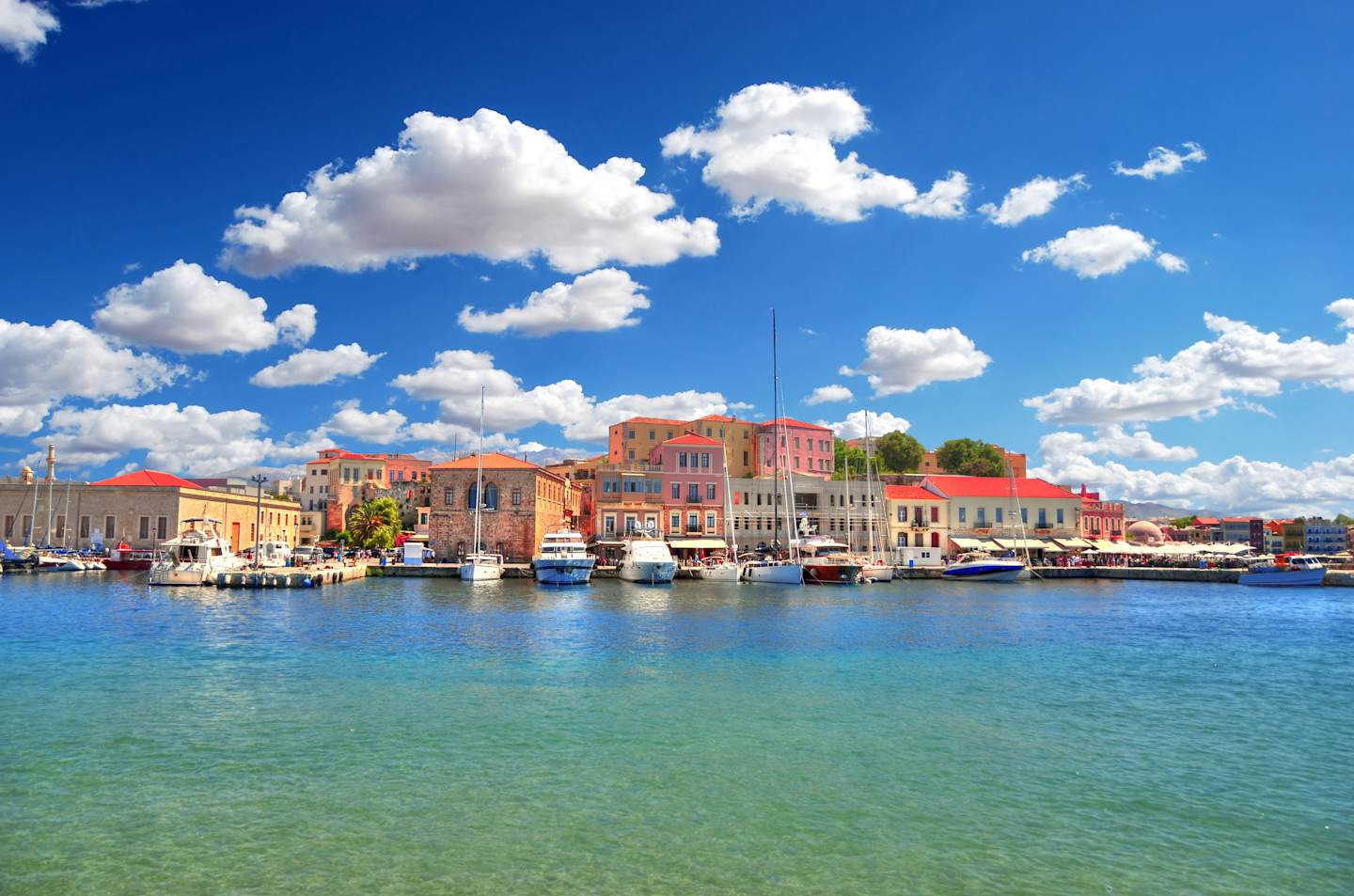 GRB post-trip extension, Colorful HDR image of the beautiful old Venetian Harbour of the city of Chania with boats and yachts on cloudy blue sky and turquoise water, Crete, Greece