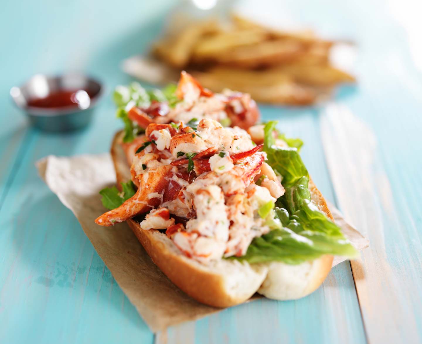 BB2  lobster roll on colorful retro painted wooden planks shot close up