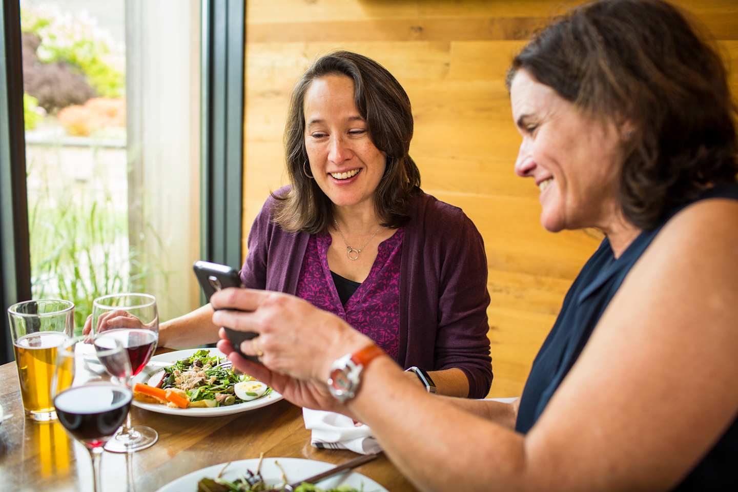 VBT Fall 2019 Photoshoot Close-up of guests talking and sharing food and photos on phone at Topnotch Resort in Stowe by JAM Creative