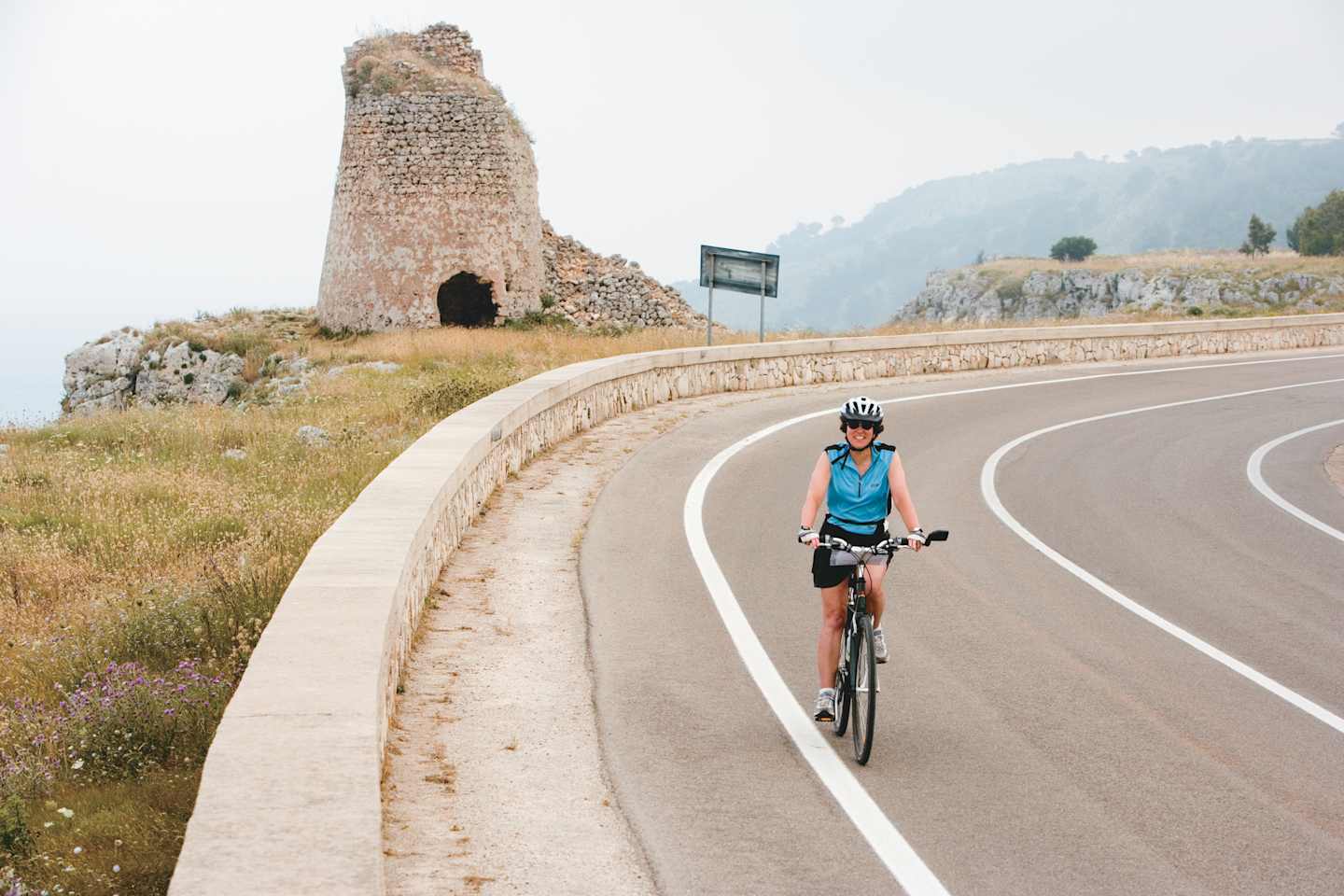 Woman cycling on road Woman cycling on road