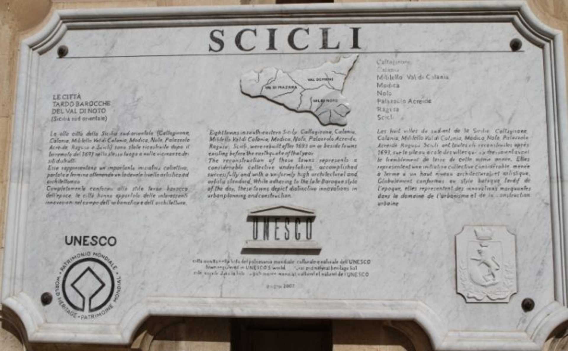 The image shows a large sign displaying the word "SCICLI" along with a map and other information about the location.