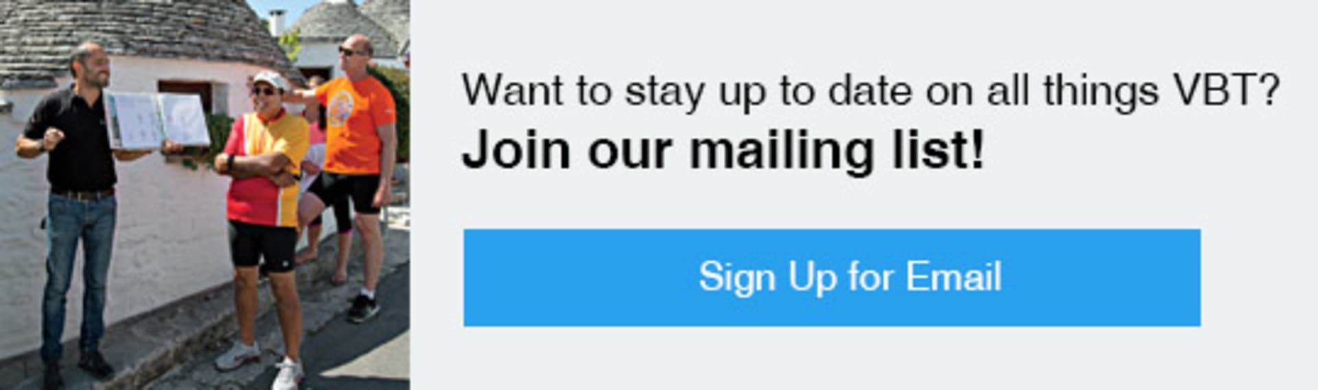 The image shows a sign encouraging people to join a mailing list in order to stay up to date on all the latest information. In the background, there is a person wearing an orange safety vest, suggesting this may be a construction or work site.