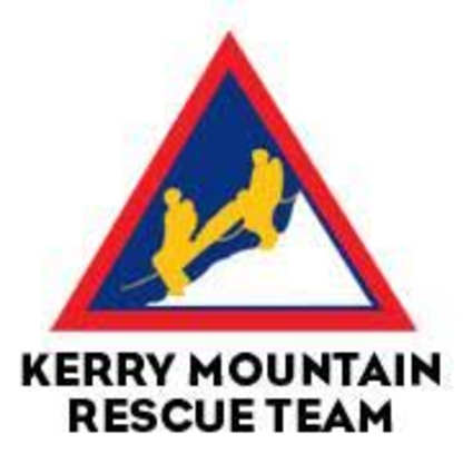 The image depicts a red and blue triangular road sign with the text "KERRY MOUNTAIN RESCUE TEAM" and a silhouette of two people in a rescue pose.