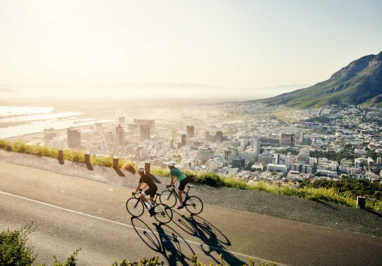 Shot of two sporty young women out cycling on a country road
