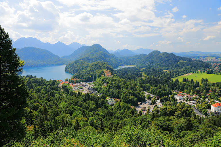 Hohenschwangau is a former village and now an urban district of the municipality of Schwangau, Ostallgäu district, Bavaria, Germany. It is located between Schloss Neuschwanstein and Schloss Hohenschwangau and is visited by about 2 million people annually, where they start tours to the former royal palaces. The village is dominated by car parks, restaurants, guesthouses, hotels and souvenir shops.
