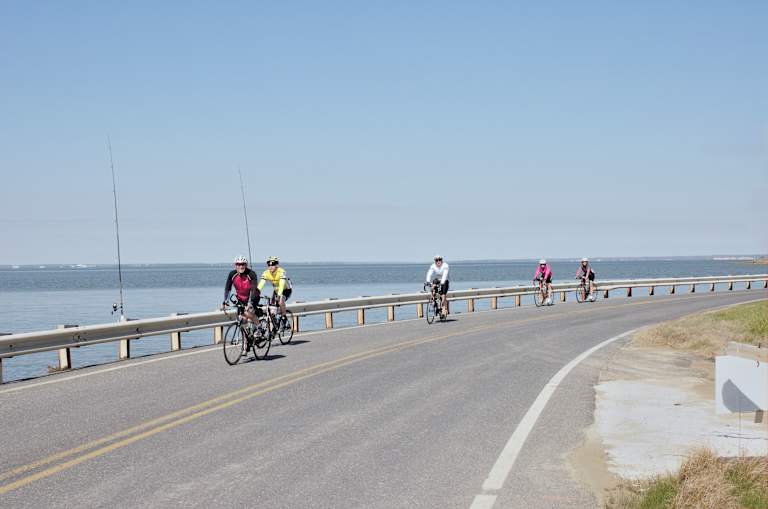 Cambridge, Maryland,USA - May 2, 2015: A group of millennials participate in a charity event bike ride on Maryland's Eastern Shore, specifically along Cat Cove off the Chesapeake bay south of Cambridge on a sunny, bright spring day on May Day.