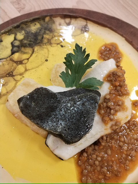 Un piatto con rombo e lenticchie in umido
