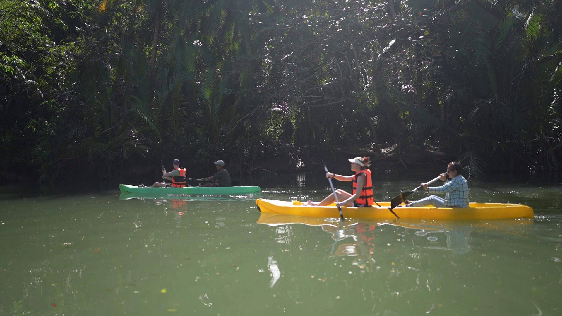 Visitors enjoying kayaking and river cruising on calm water