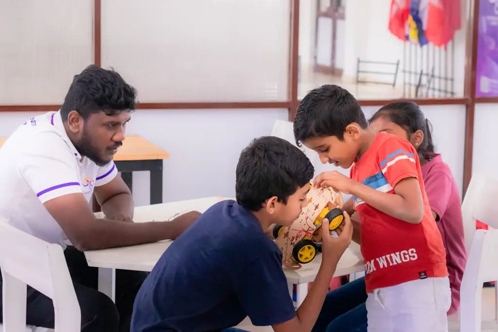 Children building their line-following cars, DreamSpace Academy Batticaloa, August 2025.
