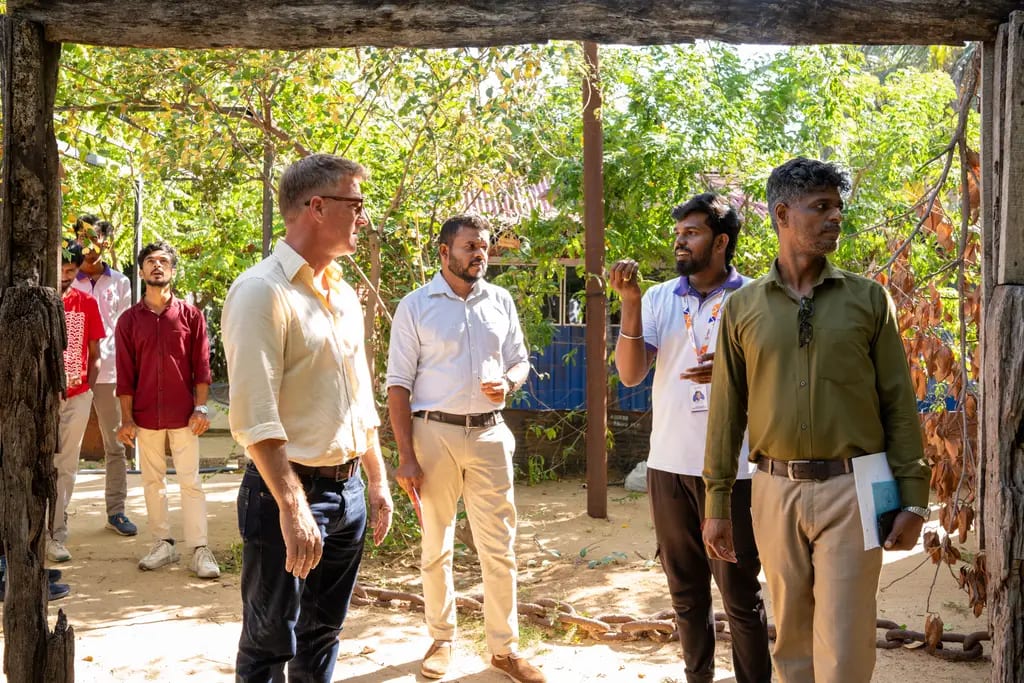 Walking the grounds during the ACTED visit, DreamSpace Academy Batticaloa, July 2026.