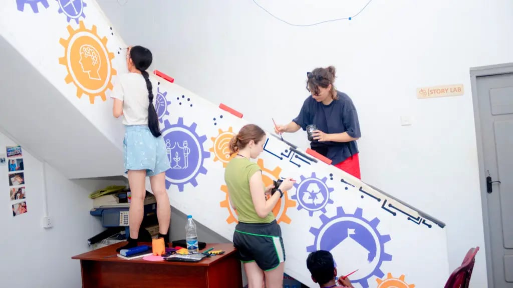 Painting the mural on the staircase together. Photo: DreamSpace Story Lab.