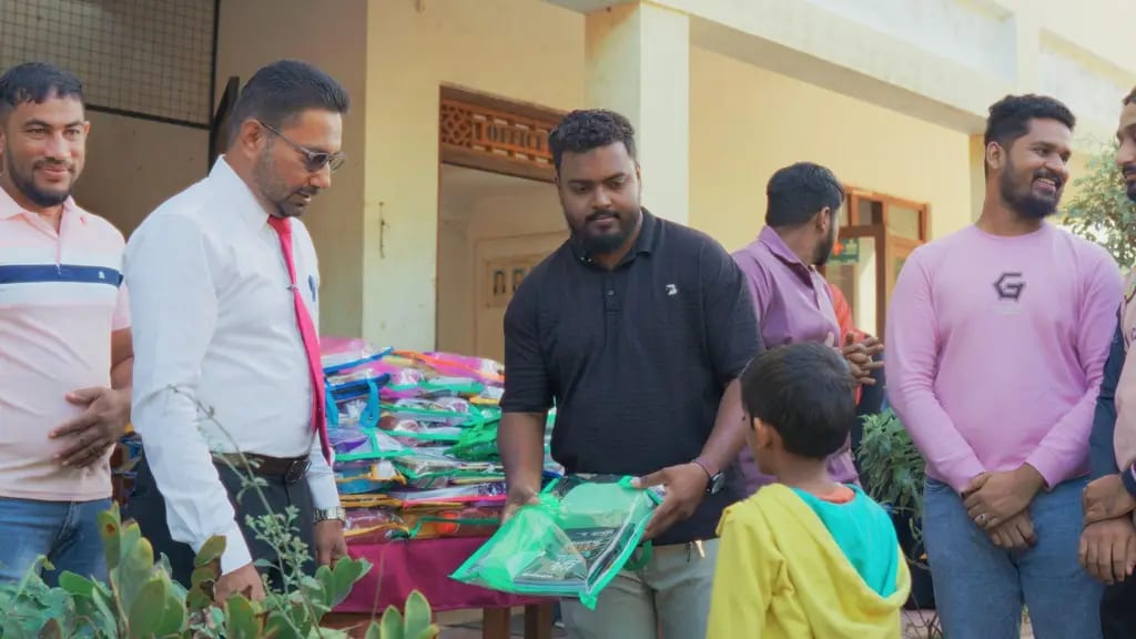 Handing a pack of school supplies to a student, Al Madeena Primary School, Polonnaruwa, December 2025.