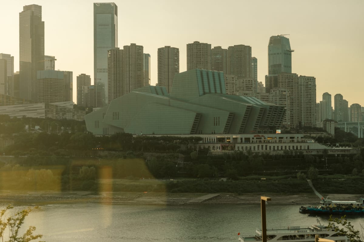 Chongqing's riverside skyline glowing in hazy evening light