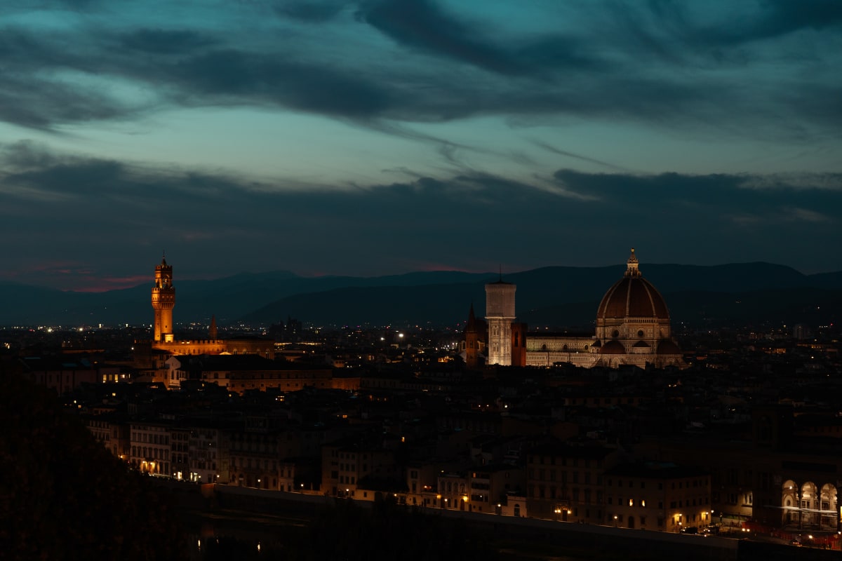 Florence Cathedral and Palazzo Vecchio illuminated beneath stormy clouds