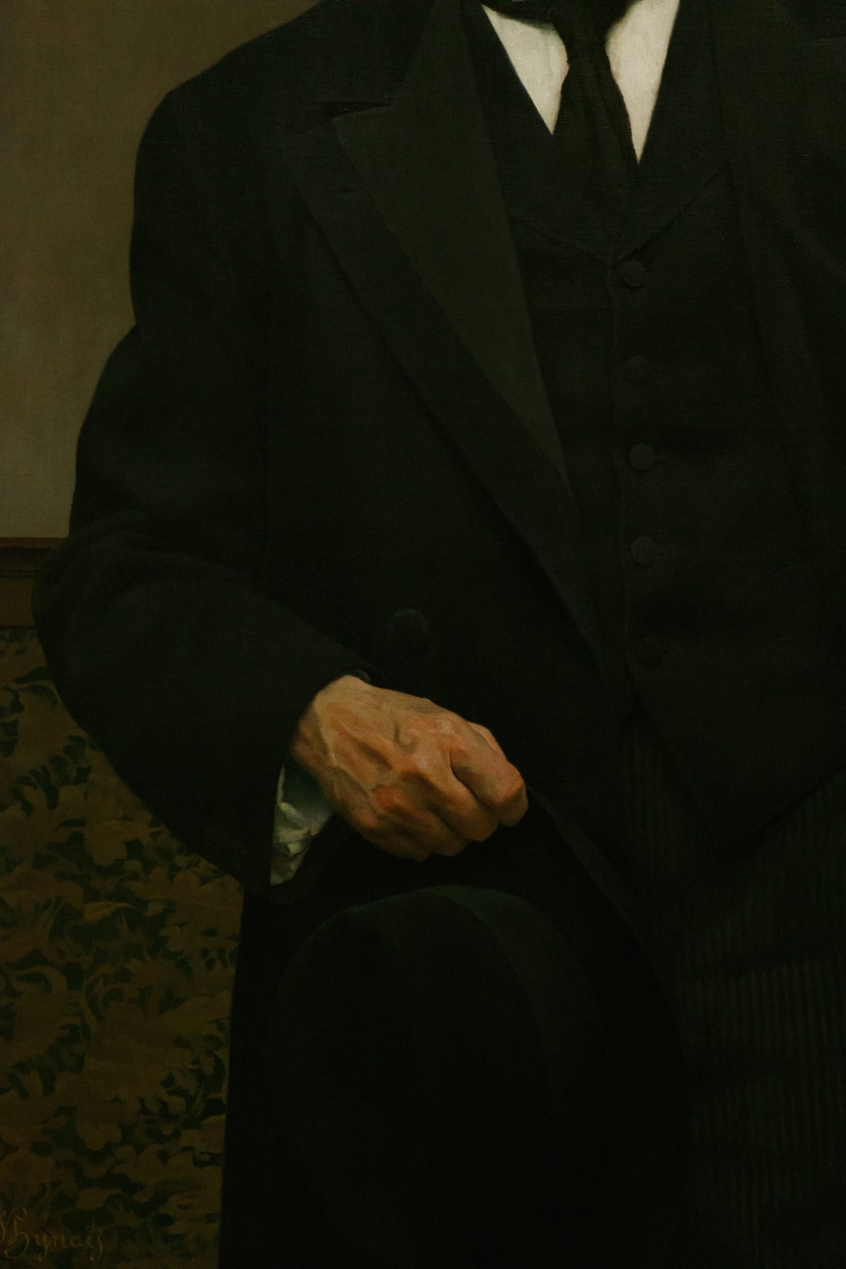 A painted gentleman's hand resting against a dark suit
