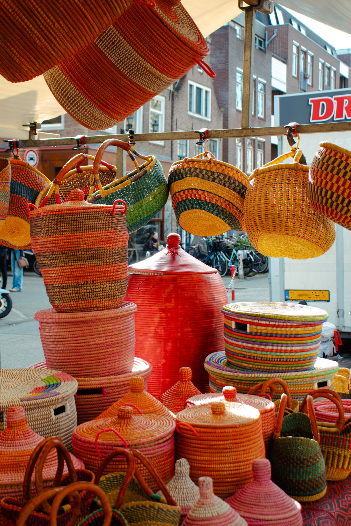 Colourful woven baskets hanging at an Amsterdam street market